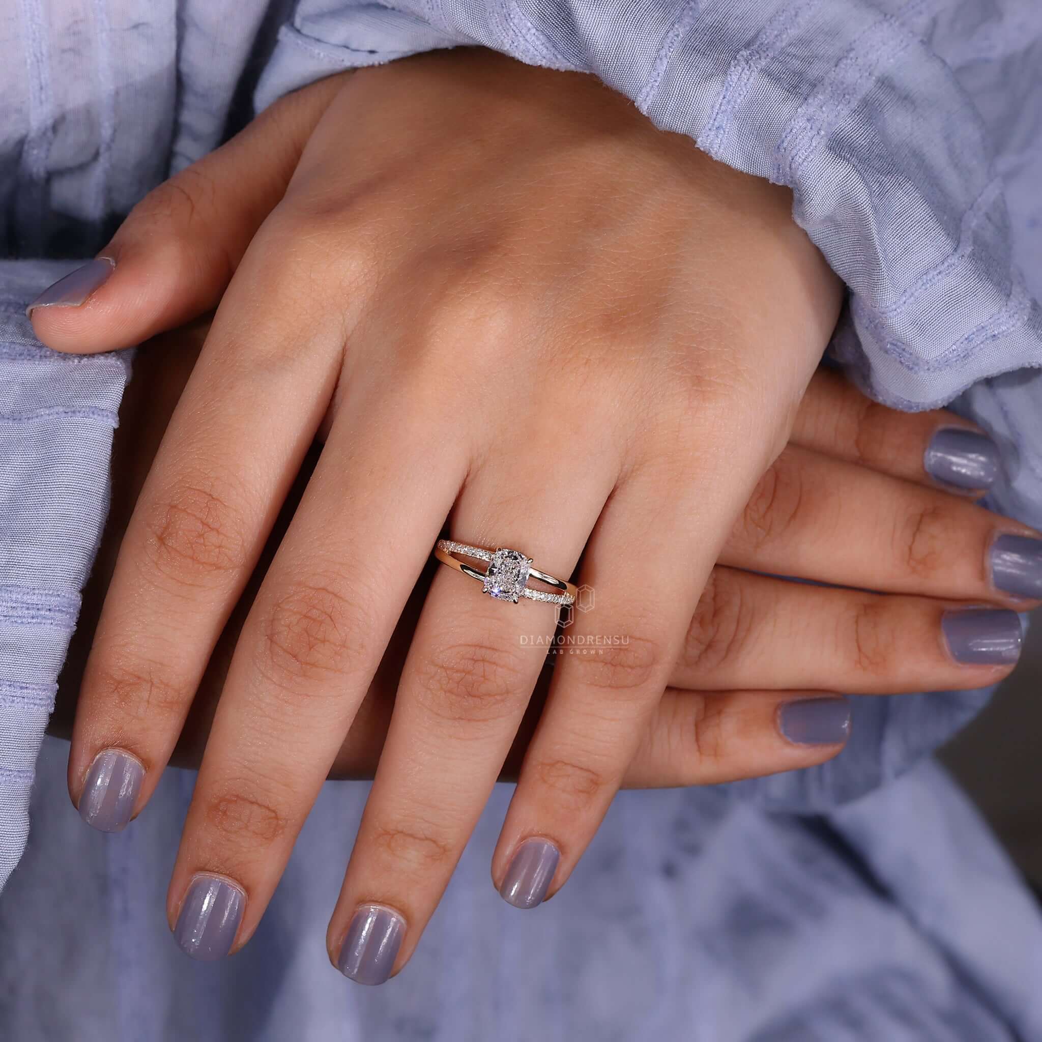 Split shank ring featuring an elongated cushion cut diamond