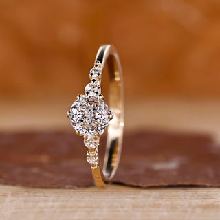 Portuguese cut diamond ring with round side stones and tapered shank.