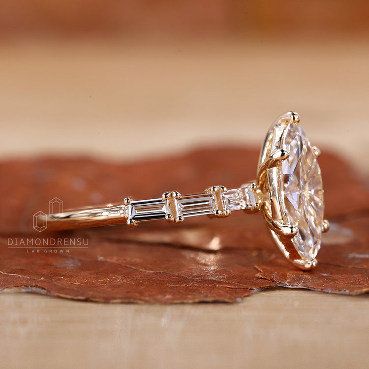 Baguette cut diamond with intricate pave setting on a gold band.
