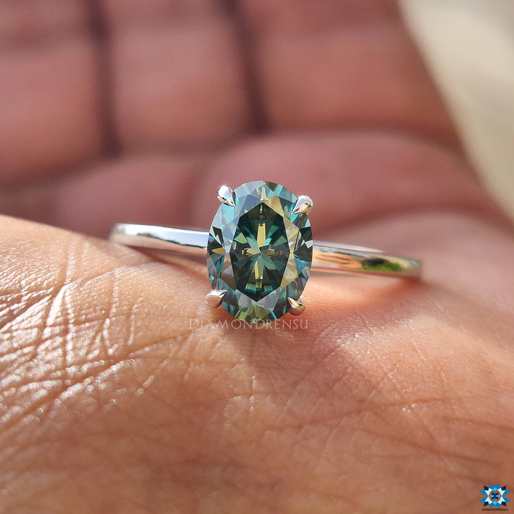 Cyan blue oval cut moissanite ring with handmade detailing.
