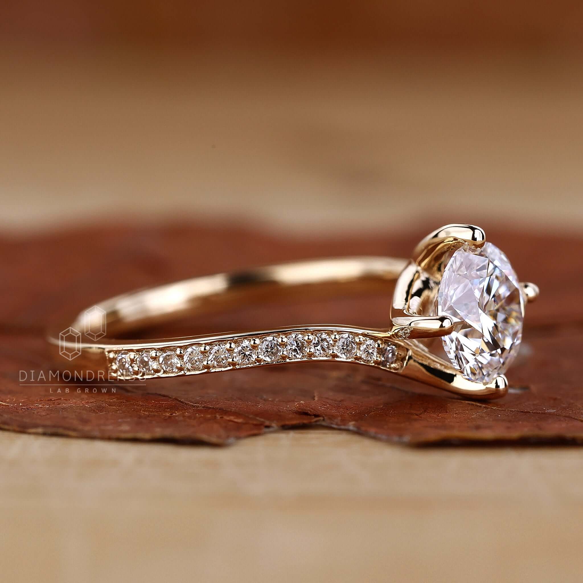 Hand wearing a dazzling bypass diamond ring, emphasizing its intricate design and sparkling stones.