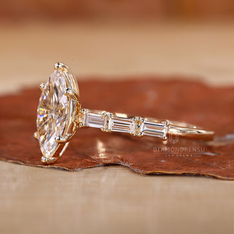 Yellow gold engagement ring with marquise centre and pave accents.
