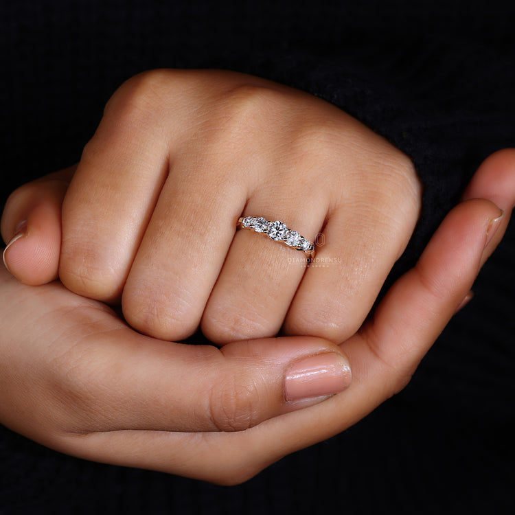 Diamond prong wedding band for modern elegance.
