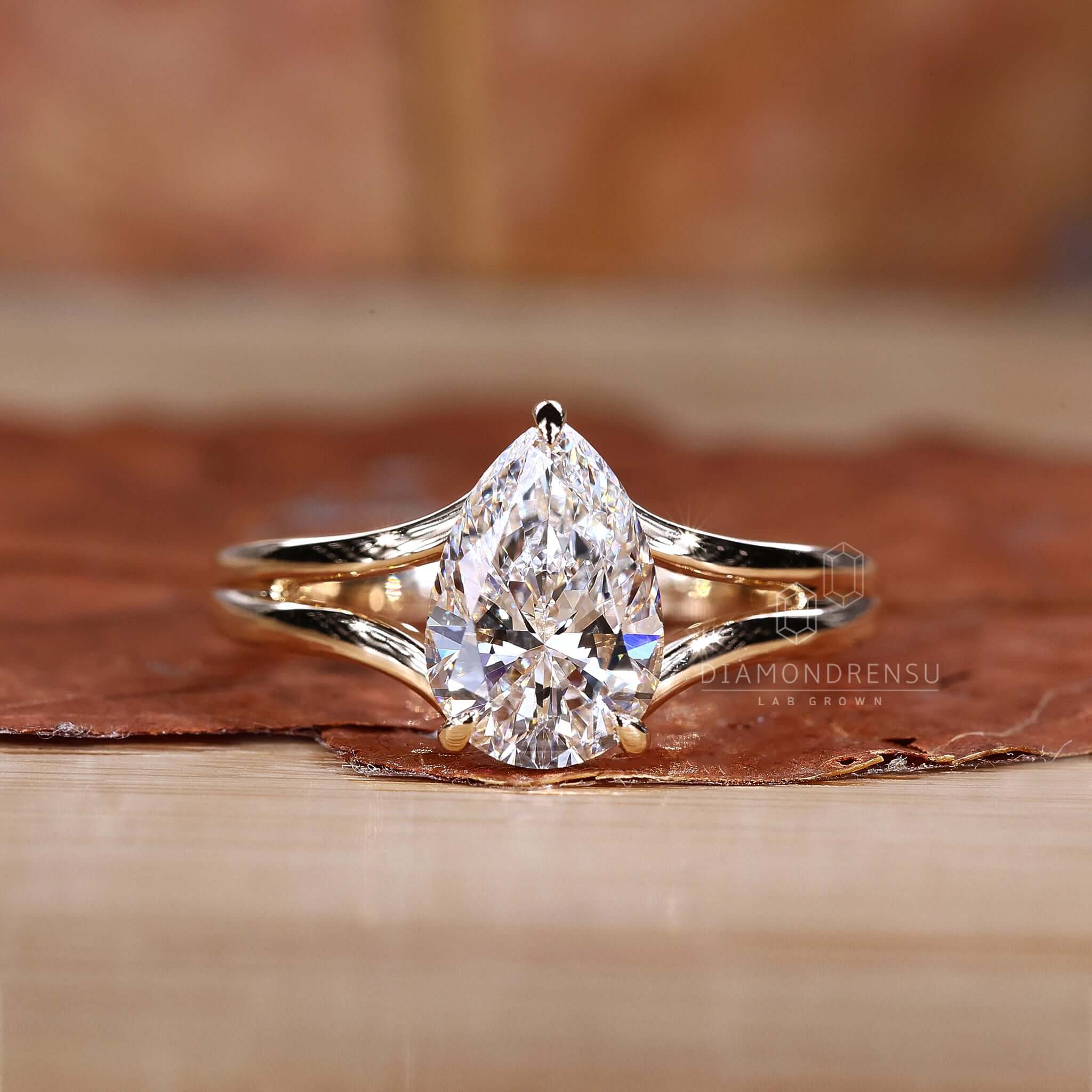 A Pear Halo Engagement Ring adorning a hand for a romantic look.