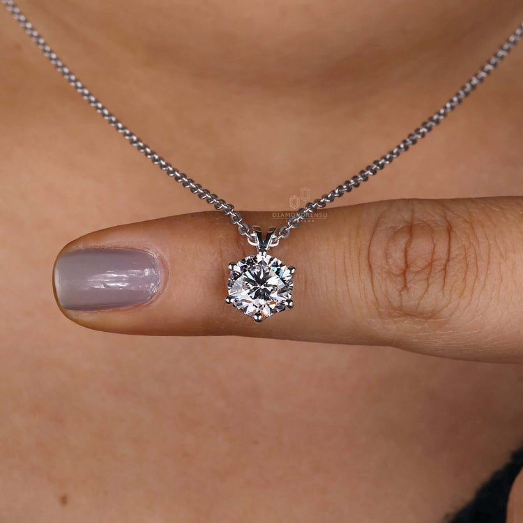 Close-up of solitaire diamond pendant in round prong setting