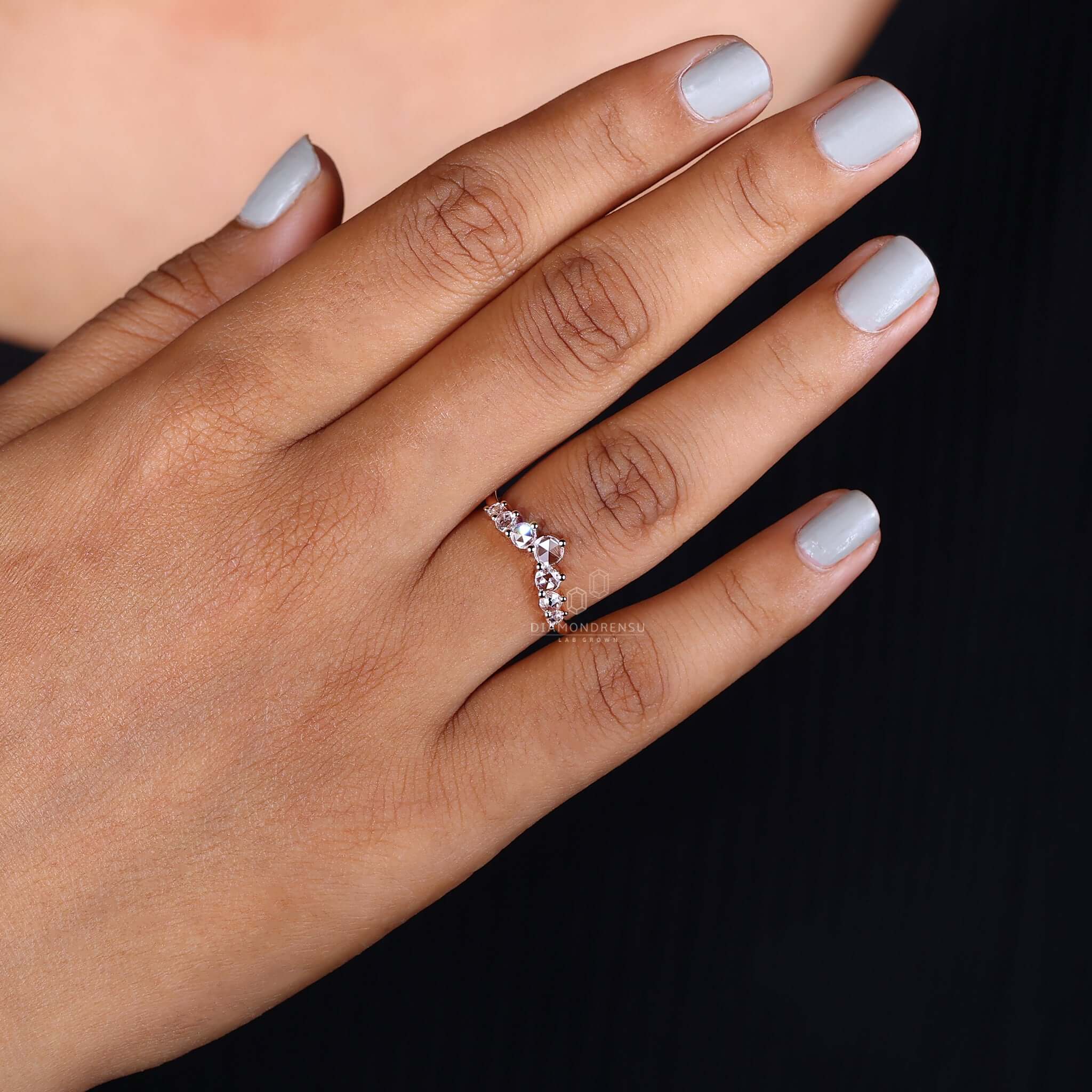 Hand wearing a lab diamond wedding band, symbolizing a commitment to love and ethical choices