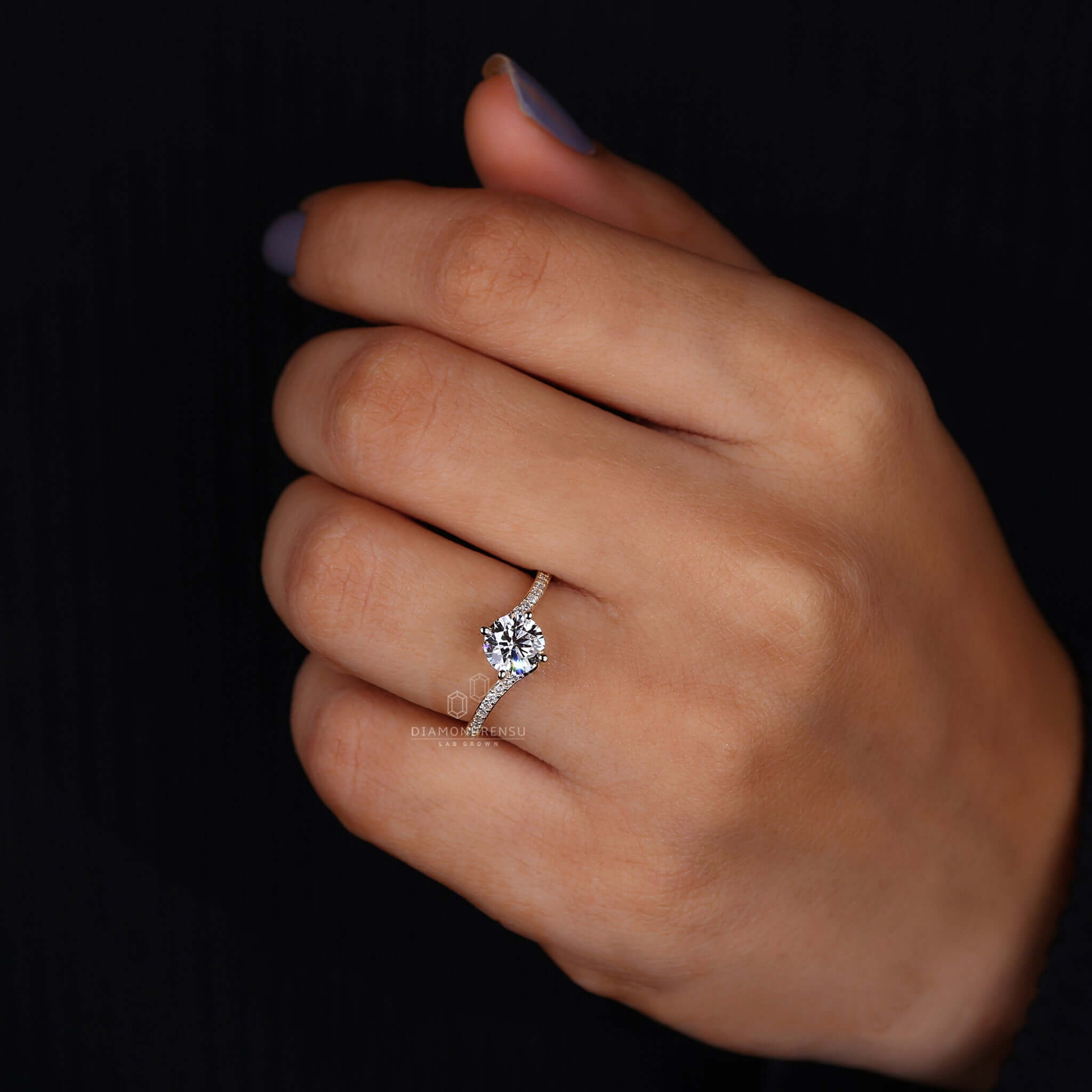 Woman's hand gracefully showcasing a bypass engagement ring, reflecting a modern twist on romance