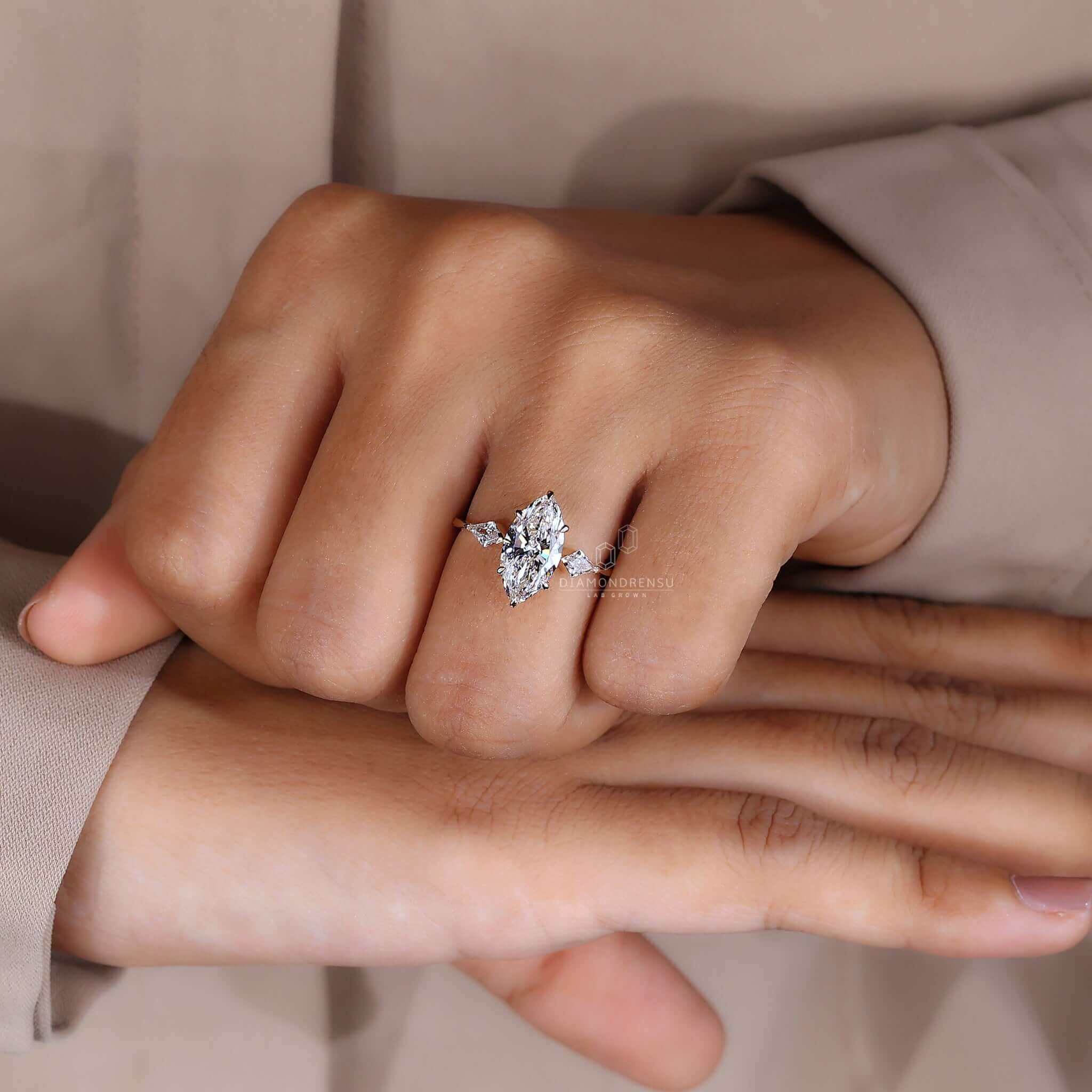 A hand wearing a big diamond engagement ring, a symbol of love and commitment.