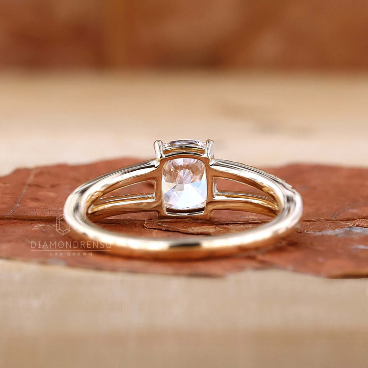 Pave diamond details accentuating the beauty of the elongated cushion cut