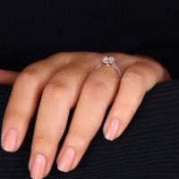 Round diamond nestled in a pave split shank setting.
