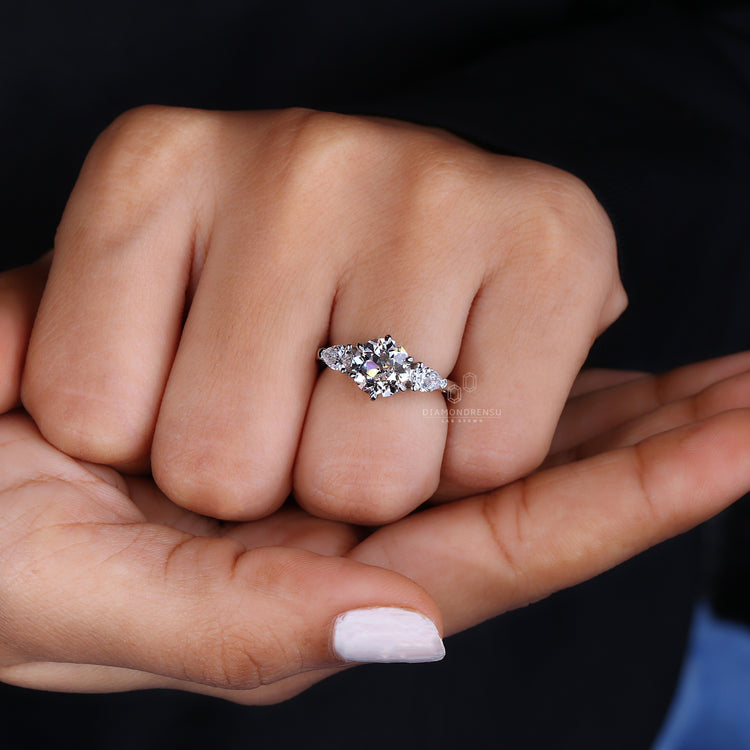 Engagement ring round with pear side stones and lab grown diamond brilliance.