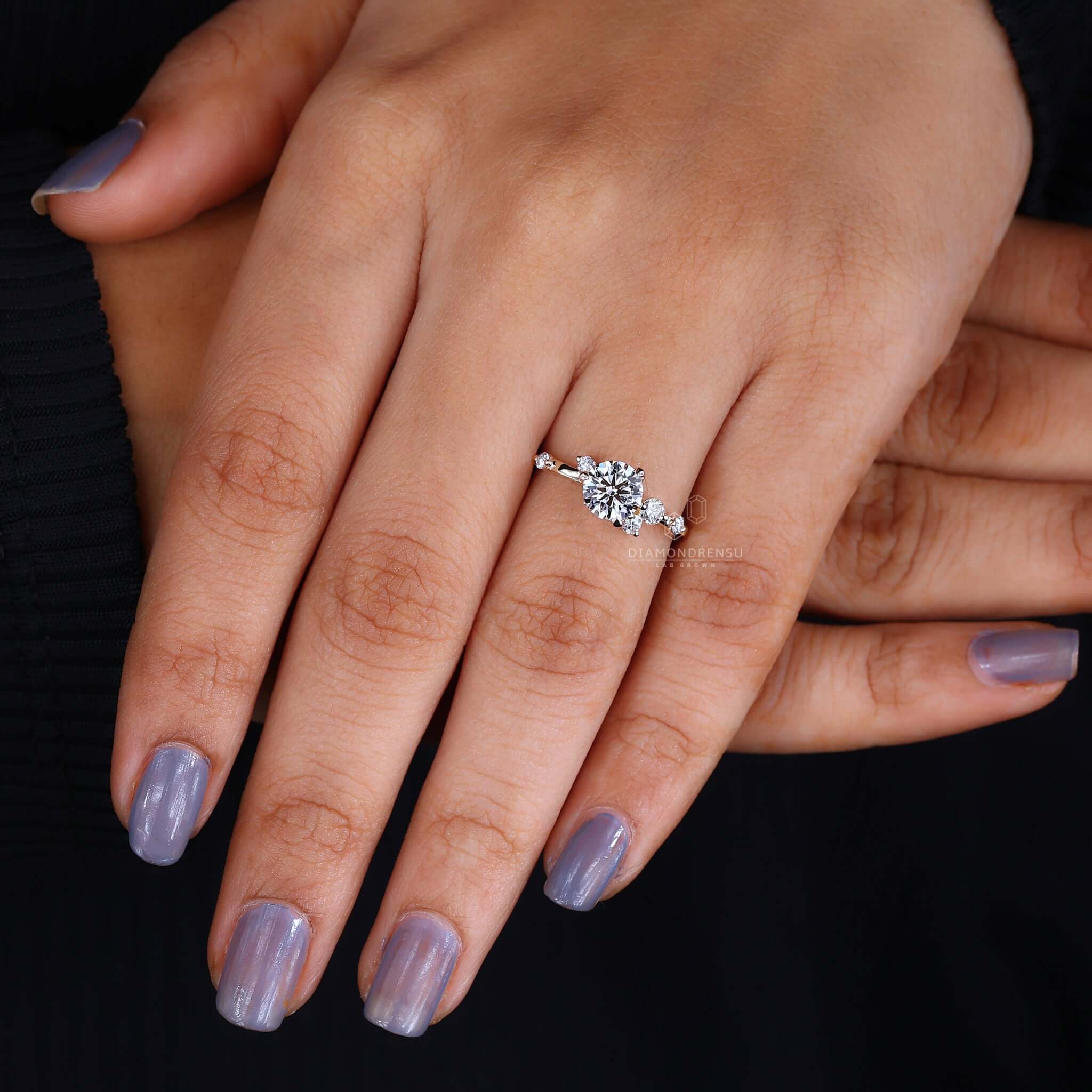 Hand model presenting a diamond cluster engagement ring, emphasizing its enchanting sparkle and love symbol
