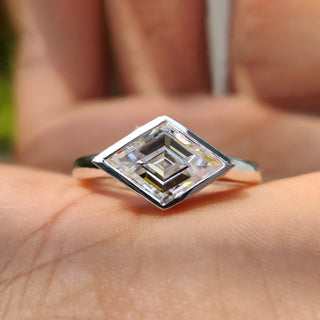 Lozenge cut engagement ring with a sleek solitaire setting.
