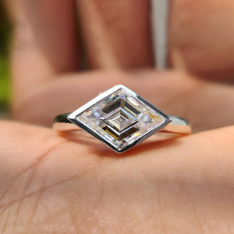 Lozenge cut engagement ring with a sleek solitaire setting.
