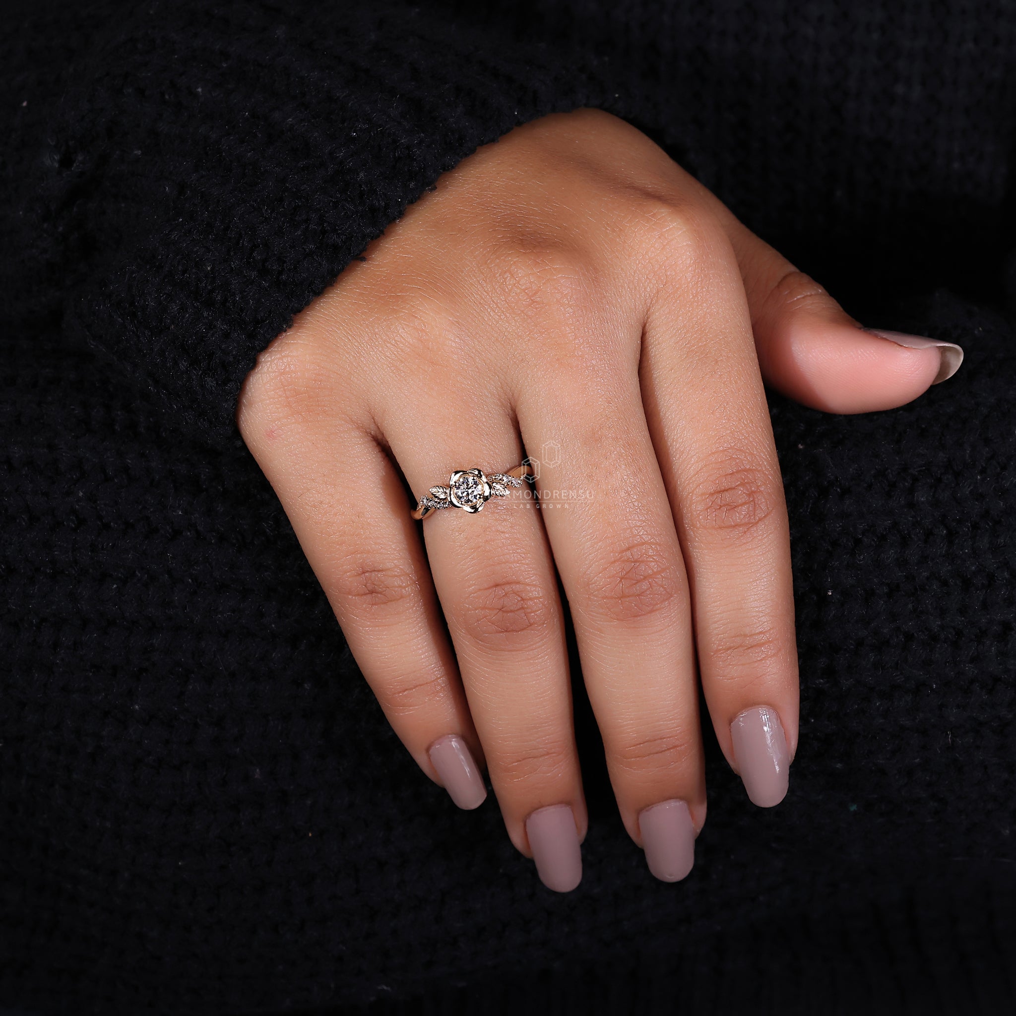 Nature-inspired engagement ring featuring a round diamond and round prongs in an elegant floral design