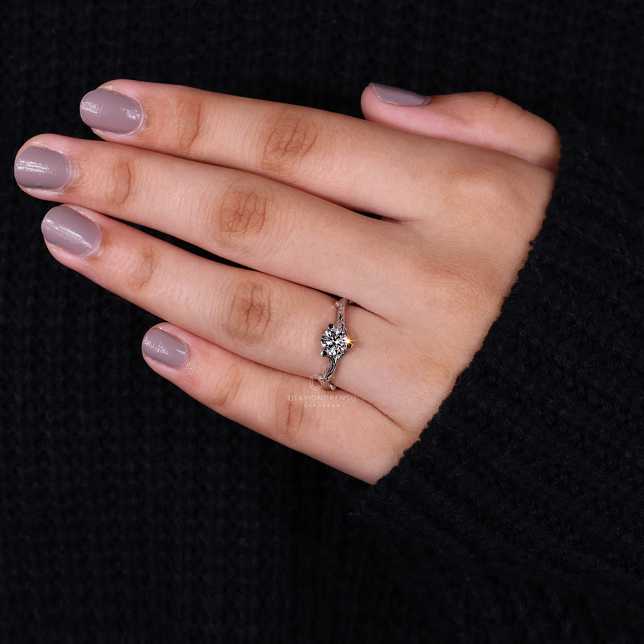 Lab-grown diamond round solitaire engagement ring with a nature-inspired white gold band and delicate branch accents