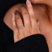 Yellow gold ring featuring Dutch marquise center and round side stones.