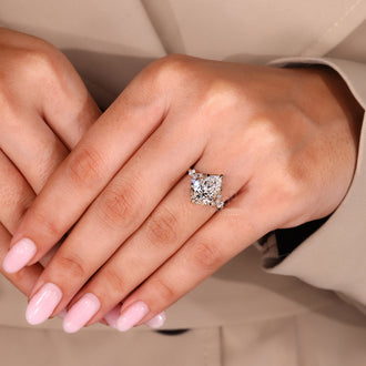 Custom diamond ring with pear cut diamond and hidden halo design.
