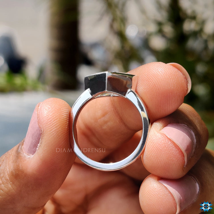 Handmade jewelry with a lozenge cut moissanite centerpiece.
