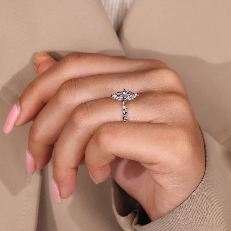 Simple diamond ring with a sleek band, designed for a minimalist look.

