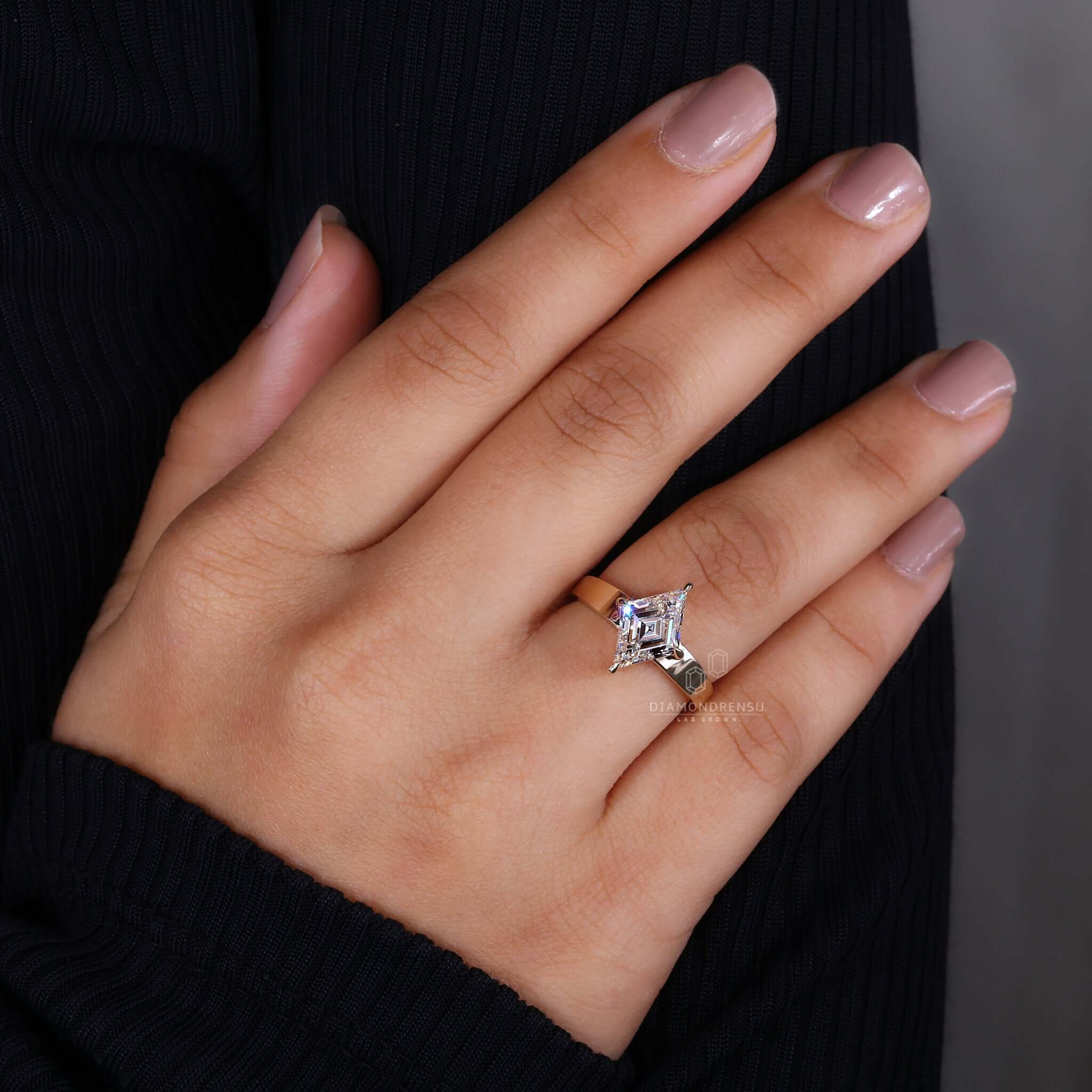 A solitaire diamond engagement ring with a unique lozenge cut, exuding timeless sophistication and elegance.