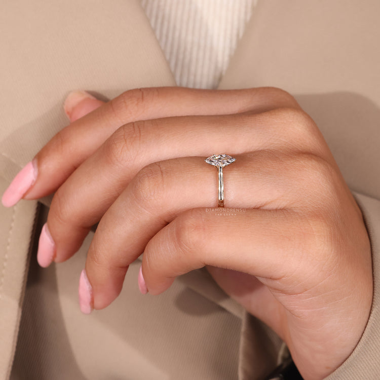 Handmade jewelry ring featuring a marquise diamond in tulip setting.
