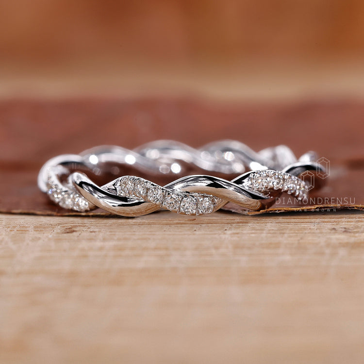 Handmade jewelry featuring a round diamond wedding band.
