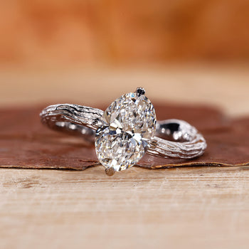 A stunning oval solitaire engagement ring with a gold band, showcasing a brilliant lab-grown diamond with claw prongs, handmade by Diamondrensu. Nature-inspired design, IGI certified.