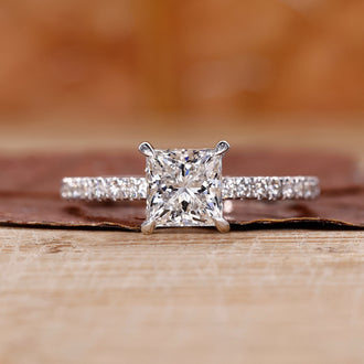 Princess cut ring with a round cut stone shines brightly.

