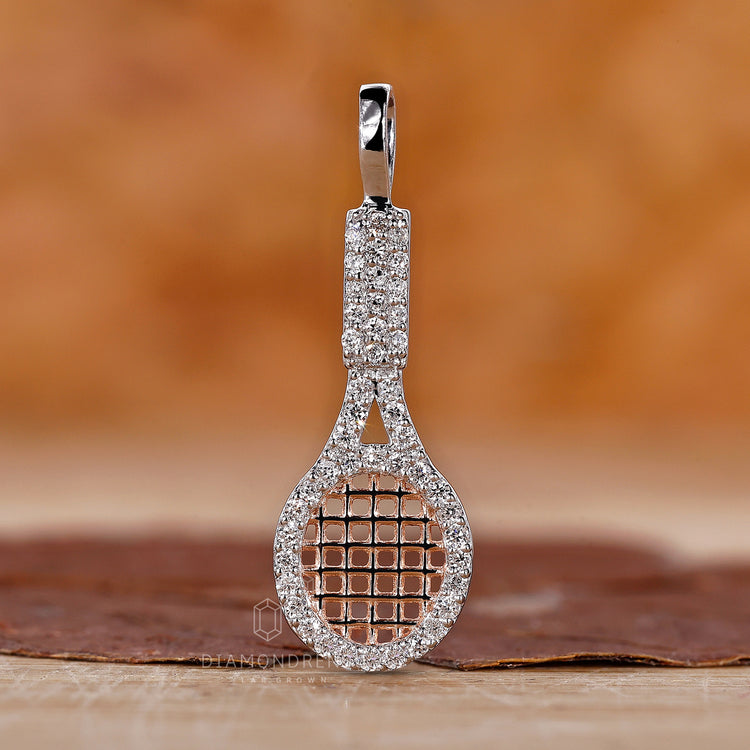 Diamond racket charm pendant with prong set and gold finish.
