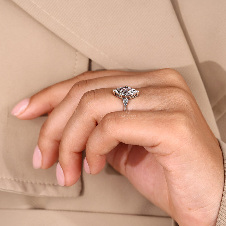 Handmade jewelry marquise and round three stone engagement ring.
