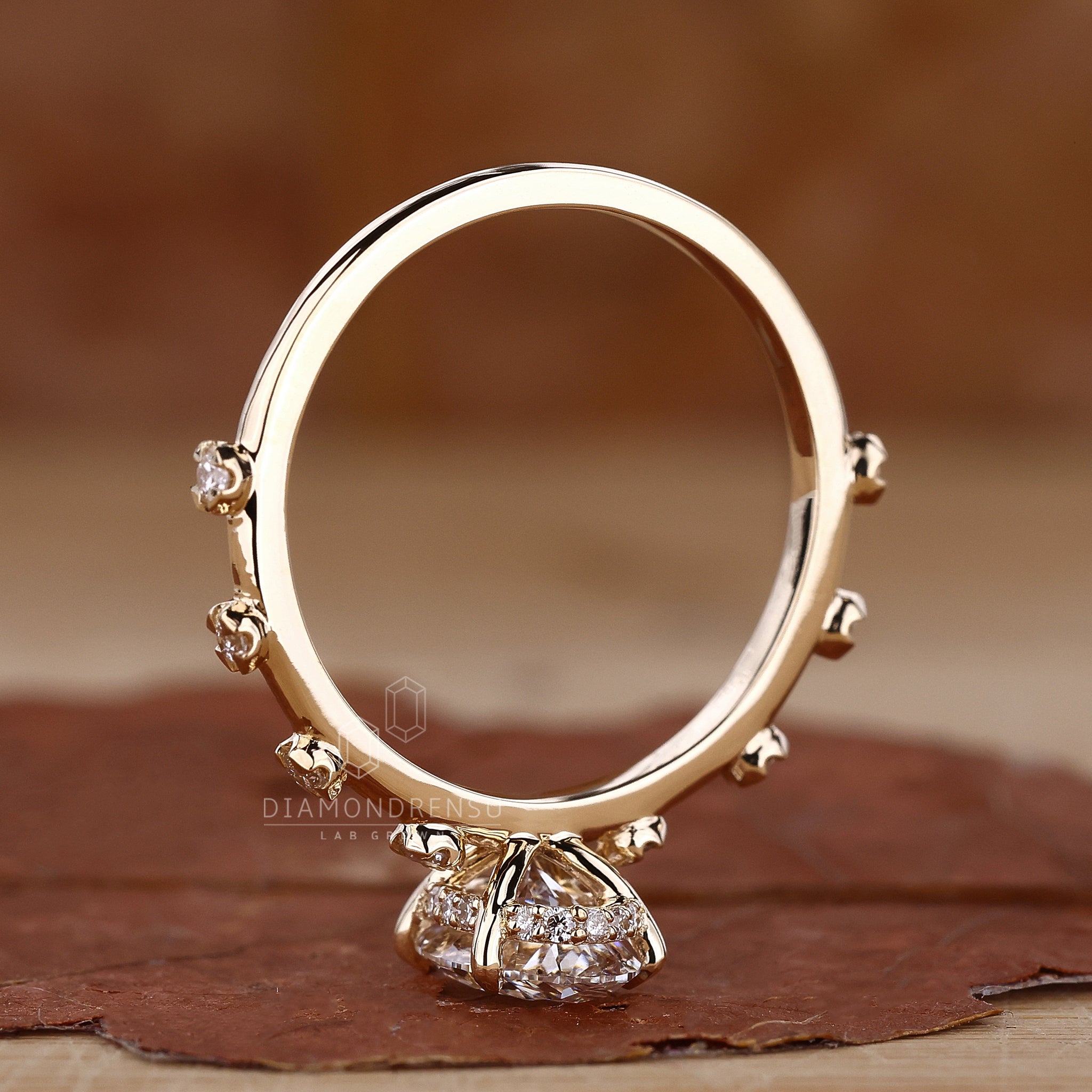 Elegant oval cut diamond ring in yellow gold with hidden halo and claw prongs, perfect for engagements.