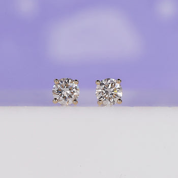 Round diamond earrings with elegant sparkle, perfect for everyday wear.
