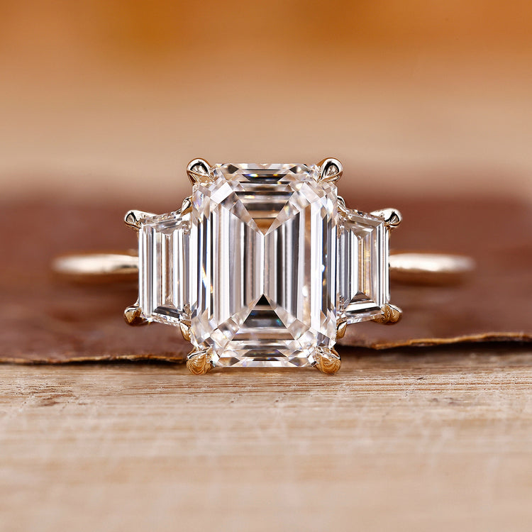 Three stone emerald cut ring with stunning diamond accents for an elegant look.
