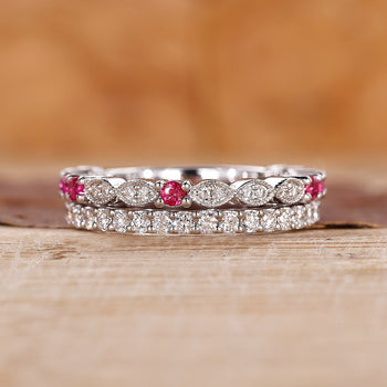 Ruby and diamond wedding band with round diamonds set in white gold.

