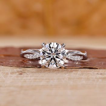 A sparkling round cut diamond ring placed on a velvet box.
