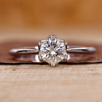 Round cut diamond ring with a sleek and elegant design.

