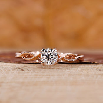 Rose Gold Solitaire Engagement Ring with a round diamond center.
