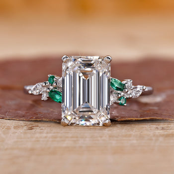 3CT Emerald Cut Diamond Ring with Marquise and Round Side Stones for a sophisticated, elegant look.

