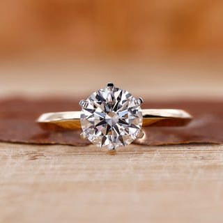 Round cut engagement ring with a brilliant center stone.
