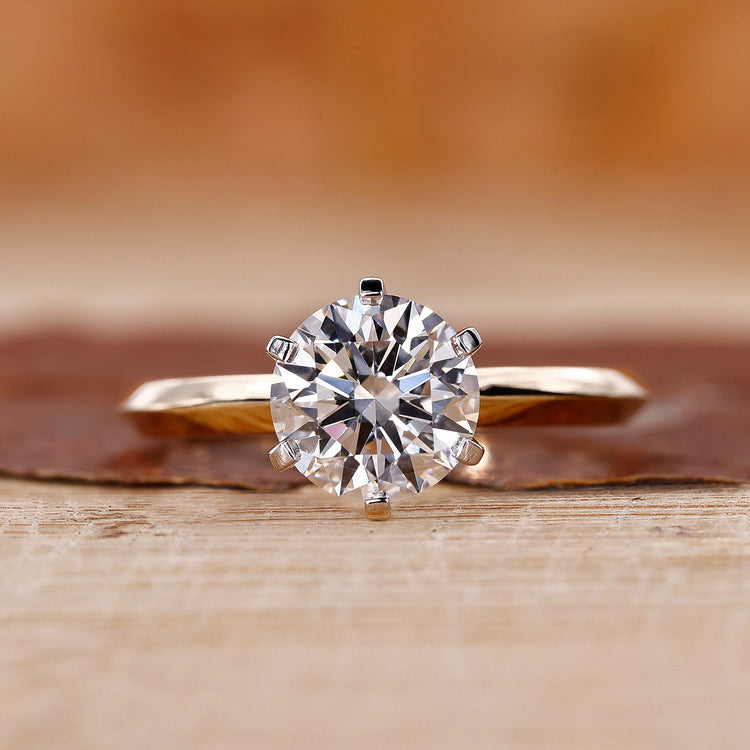 Round cut engagement ring with a brilliant center stone.
