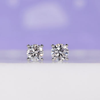 Elegant round stud earrings​ 0.70 TCW with classic design.
