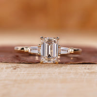 3 Stone Emerald Cut Diamond Ring with tapered baguette accents.