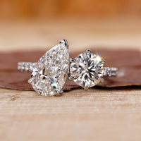 Handmade ring with pear and round diamond pave in claw prong setting.