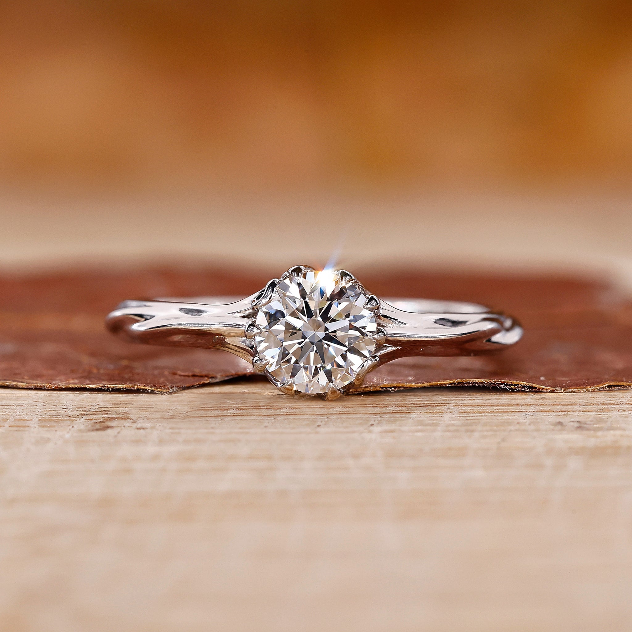 Elegant round solitaire engagement ring with claw prongs, showcasing a brilliant lab grown diamond on a delicate branch ring design