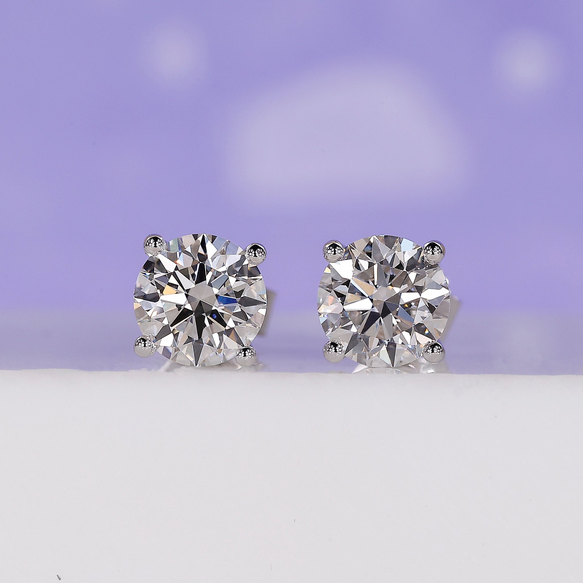 2 Carat Diamond Earrings with a timeless round diamond design in a 4 prong setting.
