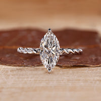 Marquise diamond ring set in a compass prong setting, offering a unique and secure hold.
