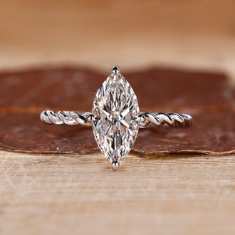 Marquise diamond ring set in a compass prong setting, offering a unique and secure hold.
