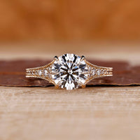 Round cut diamond ring with tapered pave setting.
