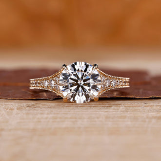 Round cut diamond ring with tapered pave setting.
